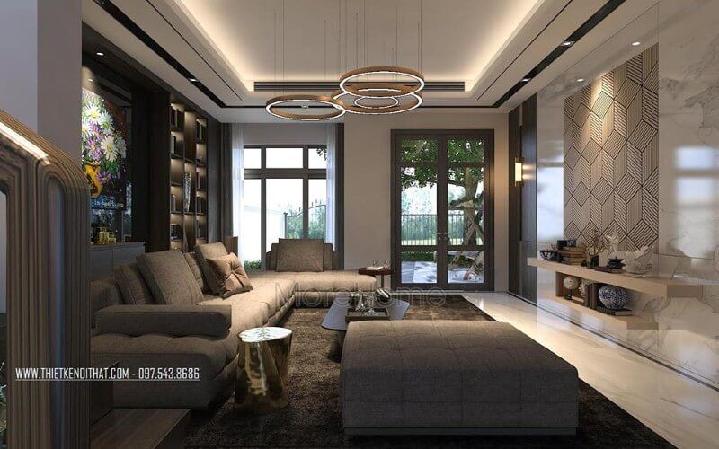 Thiết kế nội thất phòng khách ấn tượng với cách kết hợp hài hòa giữa sắc trầm và sáng cùng hệ cửa kính lớn giúp không gian trở nên thông thoáng, sang trọng.